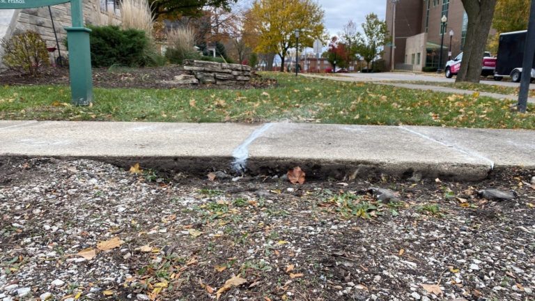 Concrete lifting foam under sidewalk.