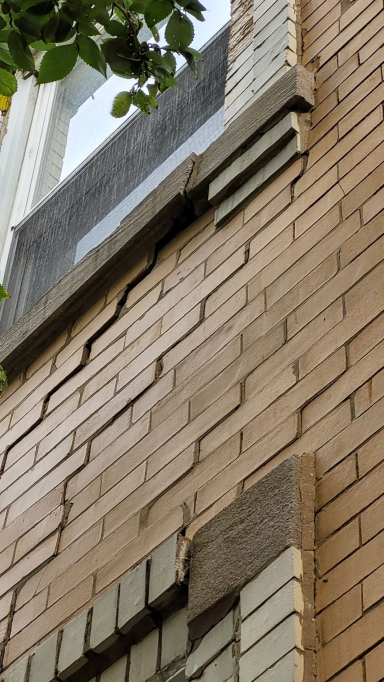 Stair step crack in brick wall