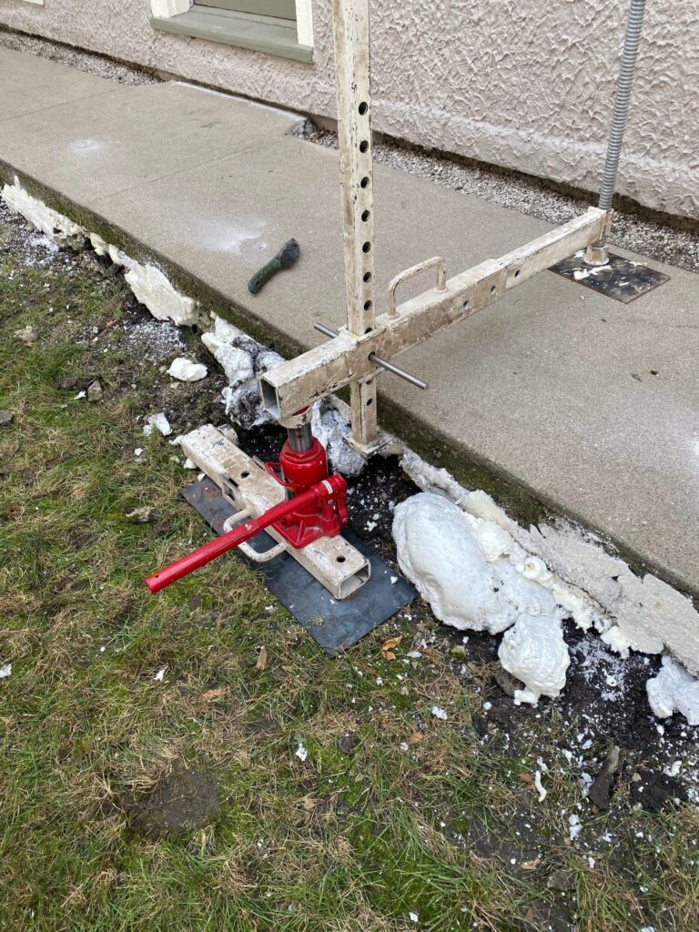 lifting a concrete slab with a jack