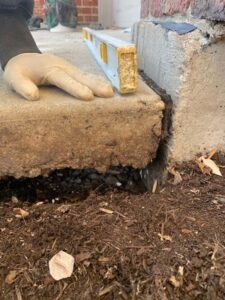 Poor drainage, tree roots, expansive soil, and improper compaction can all cause uneven concrete slabs.
