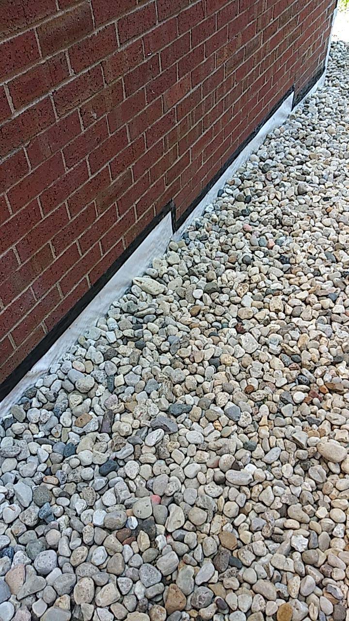 A French drain works by collecting and channeling groundwater that seeps into the foundation toward a designated outlet and then away from the foundation.