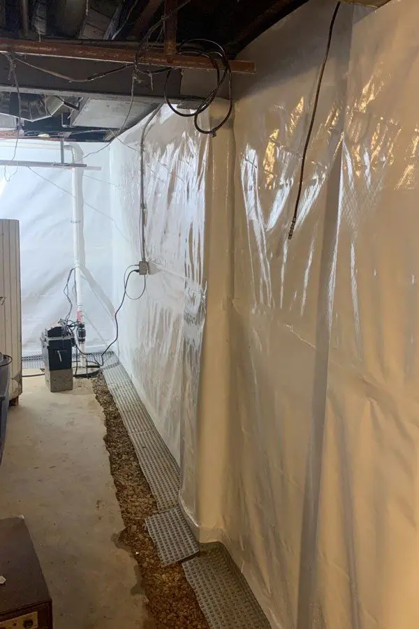 A vapor barrier is installed on the foundation walls to prevent water from entering the basement through the basement walls.