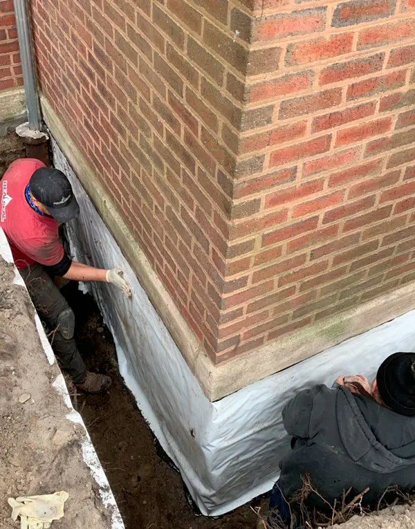 A foundation waterproofing membrane is a protective barrier installed around the exterior of a building's foundation. Its primary purpose is to prevent water and moisture from penetrating the foundation walls, which can cause structural damage and mold.
