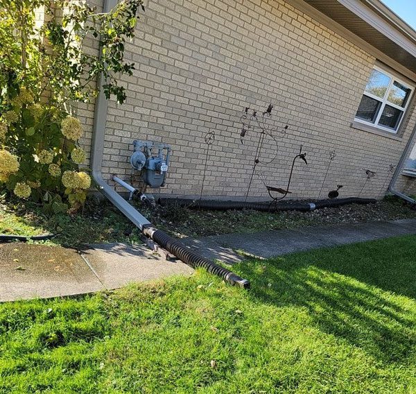 Discover the pros and cons of buried downspouts, how to mitigate the top 6 problems, how to maintain them, and potential alternatives.