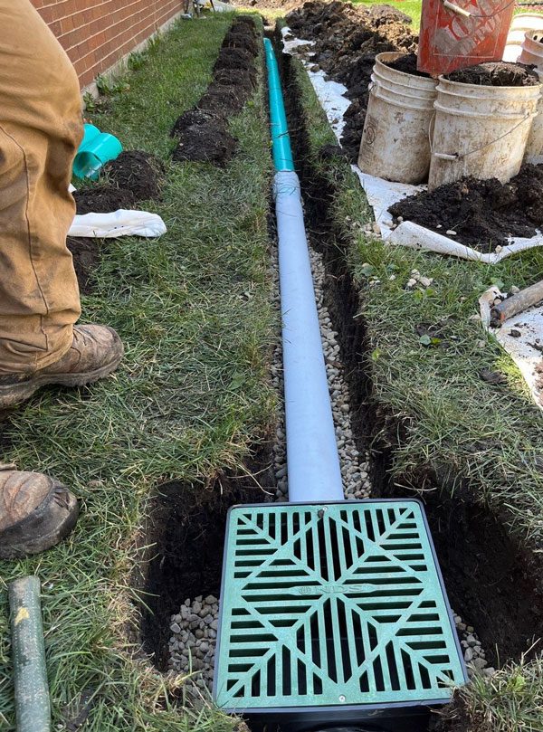 Installing drainage systems like French drains, sloping the ground away from the slab, and using gravel or other permeable materials can help manage water flow and keep the area dry.