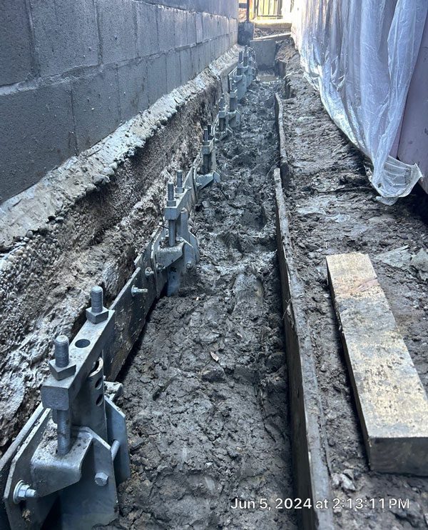 Underpinning involves extending the foundation in depth or breadth so it rests on more supportive soil or distributes its load across a larger area.