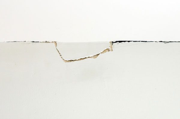 Explore the common causes of cracks where a wall meets the ceiling, from settling foundations to structural shifts, and learn how to identify and fix these issues.