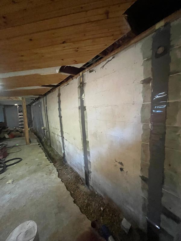Carbon fiber straps are applied to the interior walls, strengthening and preventing further bowing.